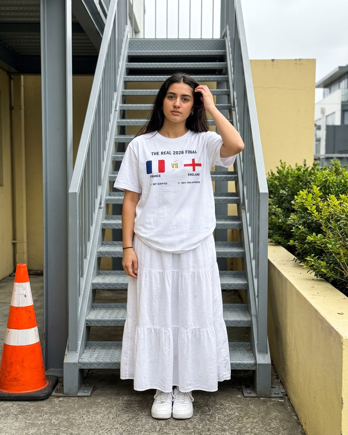 Fan by an outdoor staircase wearing The real final France VS England tee